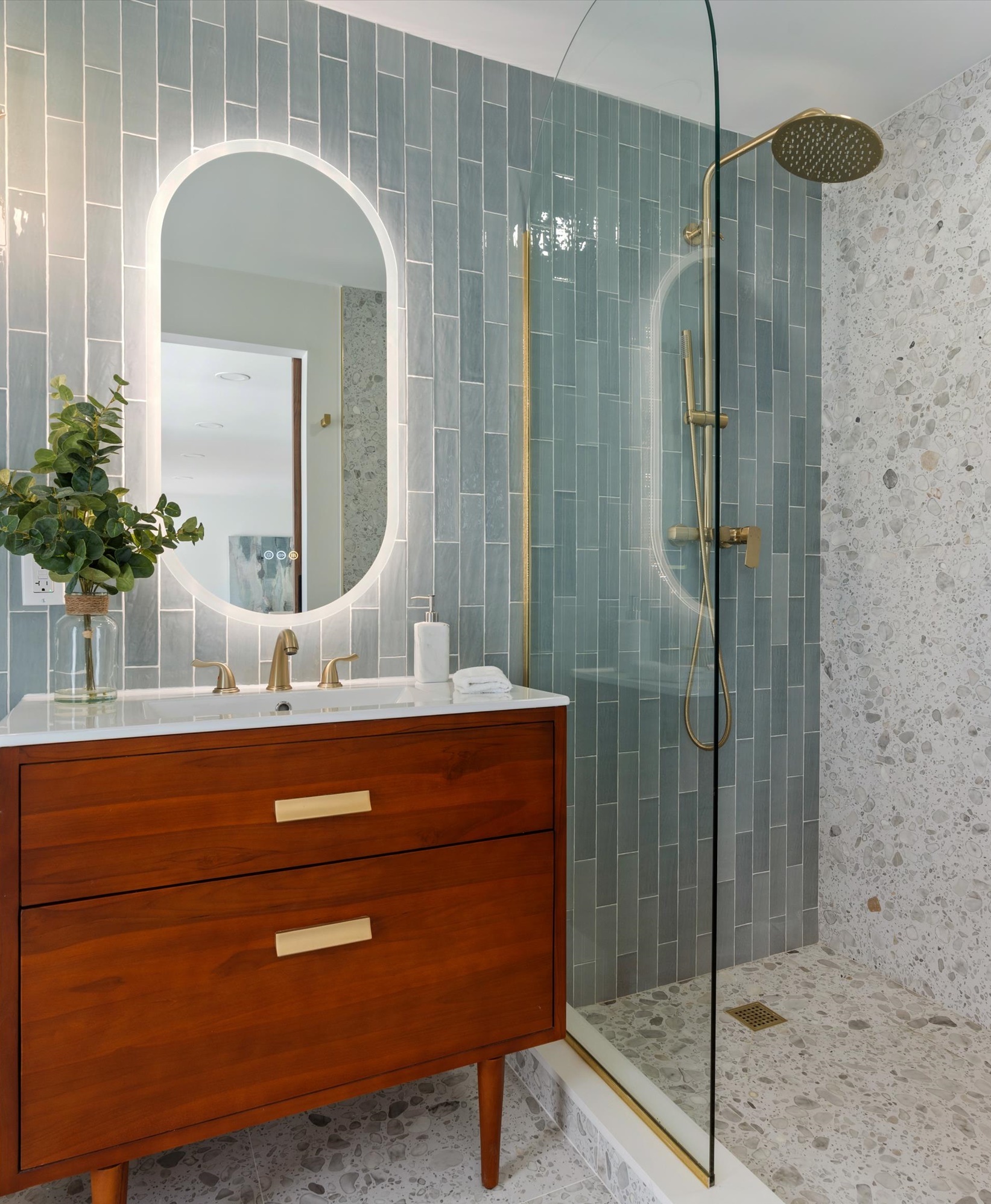 Delray Beach bathroom remodel with teal vertical tile, walnut vanity and brass fixtures